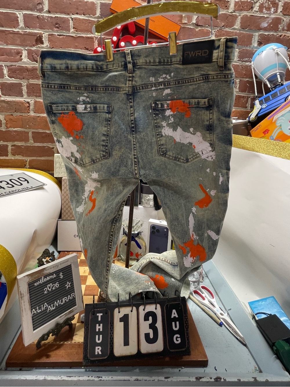 pair of Switch Remarkable Destroyed Orange Painted Slim Tapered Jeans featuring